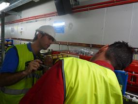 David and Eric rescrew the connectors for the power and but a nut on the other side of the plate